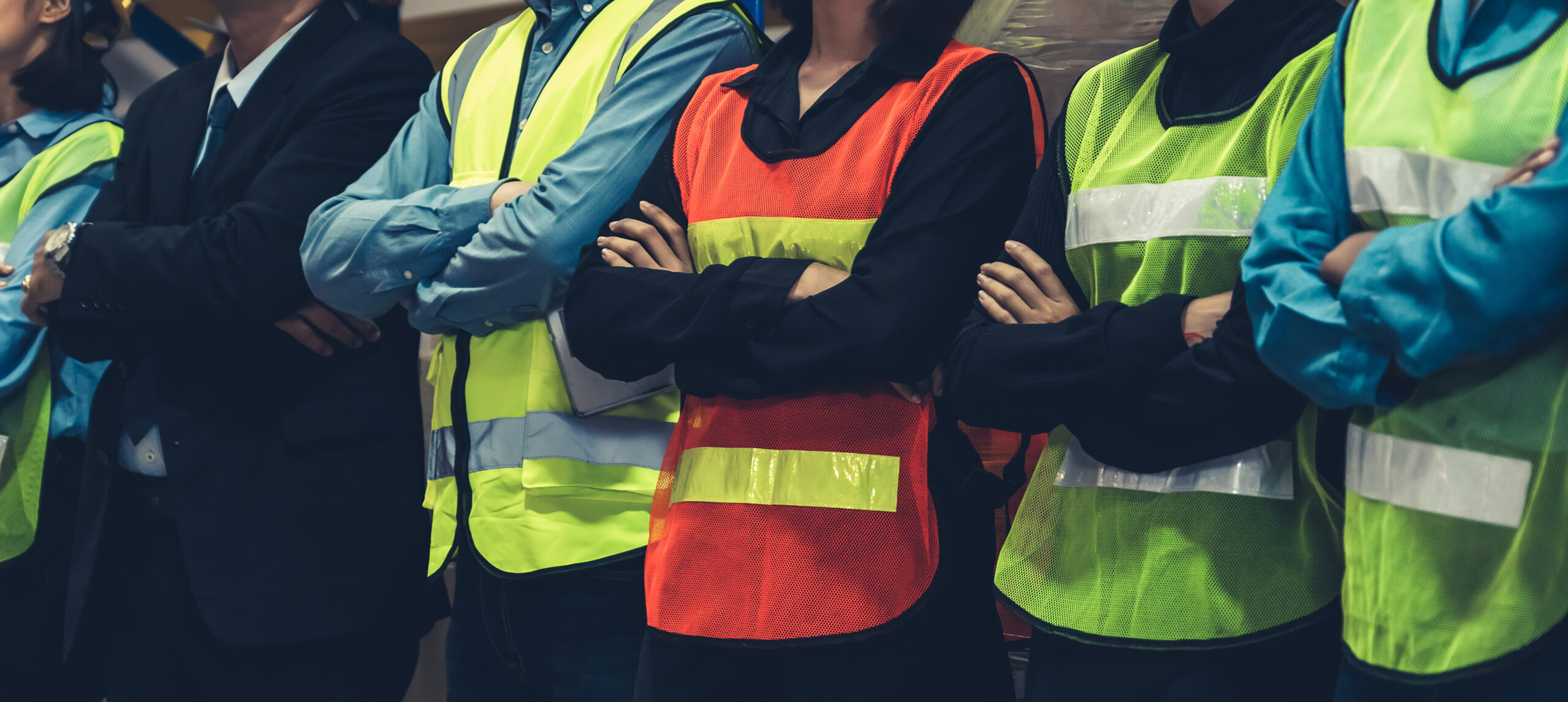 Large group of factory worker standing together in warehouse or storehouse . Logistics , supply chain and warehouse business concept .